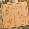 Personalised wooden chopping board engraved with children's drawings and custom text, creating a unique keepsake gift from a child's artwork.
